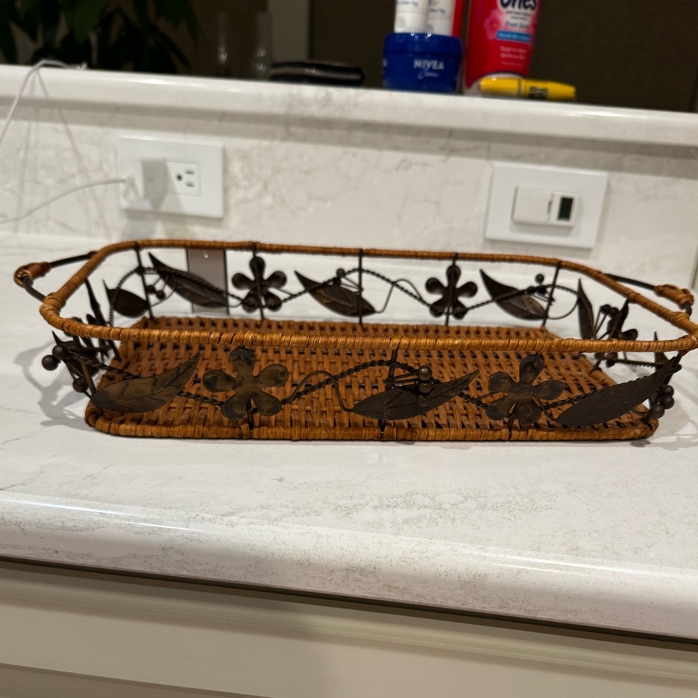 basket featuring a woven rattan or bamboo base with a dark metal frame